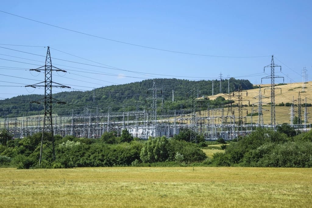 Electrical substation among green hills