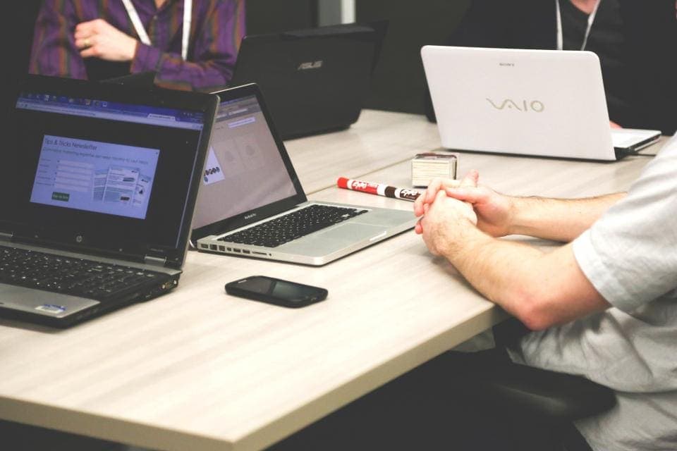 Team working on laptops at a desk